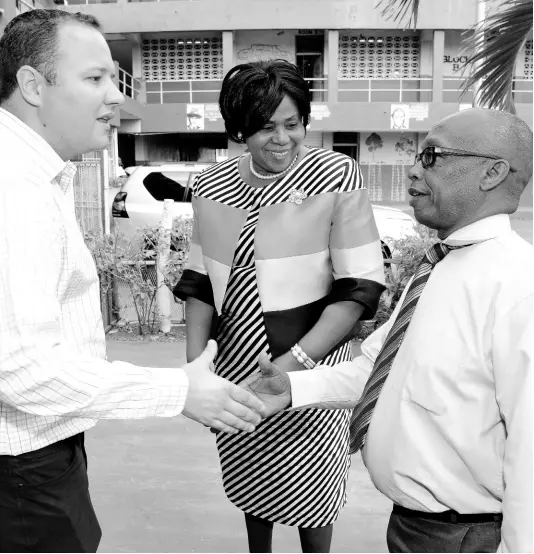  ?? CONTRIBUTE­D ?? Lexford Johnson (right), principal of Norman Gardens Primary School, is introduced to Peter Donkersloo­t, general manager of Caribbean Cement Company, by Dr Margaret Bailey, principal of Rollington Town Primary School, during a school tour on Monday, March 11. Caribbean Cement donated $724,000 to help fund a reading programme that benefits seven primary schools and 300 students in the east Kingston area.