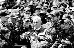  ?? JAMAL MCNEILL/U.S. NAVY ?? Vice President Mike Pence takes a selfie with sailors Wednesday aboard the USS Ronald Reagan at the U.S. Yokosuka naval base in Tokyo Bay. “The sword stands ready,” he said.