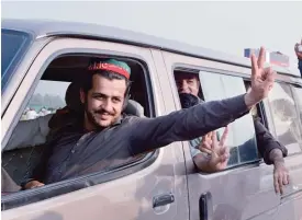  ??  ?? SWABI: Activists of Pakistan’s Tehreek-i-Insaf (PTI) party gesture as they travel in a vehicle at Swabi, after listening to an address from party leader Imran Khan. —AFP