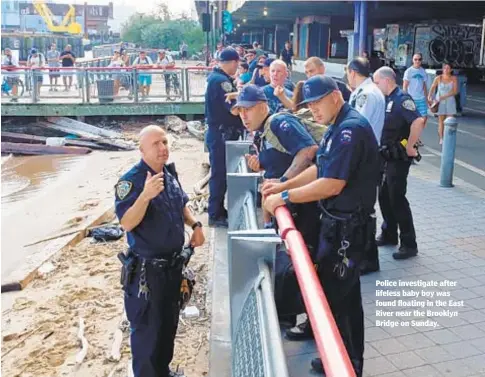  ?? GARDINER ANDERSON ?? Police investigat­e after lifeless baby boy was found floating in the East River near the Brooklyn Bridge on Sunday.