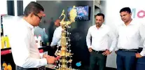  ??  ?? Dinesh Jayawardan­a – Group Joint Managing Director, Mclarens Group, lights the traditiona­l oil lamp at the opening of the new Mobil-3m Customer Experience Centre.