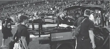  ?? COLE BURSTON/THE CANADIAN PRESS ?? Argonauts quarterbac­k Ricky Ray is taken off the field on a stretcher Saturday during a game at BMO Field.