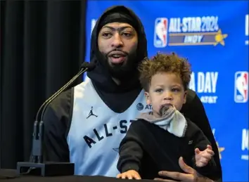  ?? Michael Conroy/Associated Press ?? TAGGING ALONG Los Angeles Lakers forward Anthony Davis had some help answering questions Saturday from son Jayce during NBA All-Star media day in Indianapol­is.