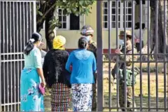  ?? STR/AFP ?? Members of the Arakan Women Network speak to soldiers outside a military court in Sittwe on December 11.