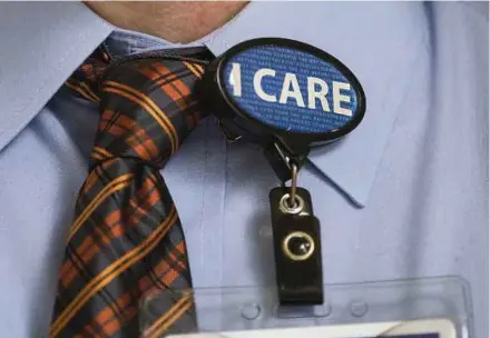  ?? NYT PIC ?? A tag on a male nurse’s collar at a hospital in Portland, Oregon. For some men, the notion that caregiving jobs are women’s work is outdated.