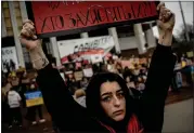  ?? AP PHOTO/ ENRIC MARTI ?? A woman holds a sign during a protest in Kyiv, Ukraine, Sunday March 24, 2024, to demand the freedom of Ukrainian Mariupol’s Azovstal defenders still being held prisoners by Russia.