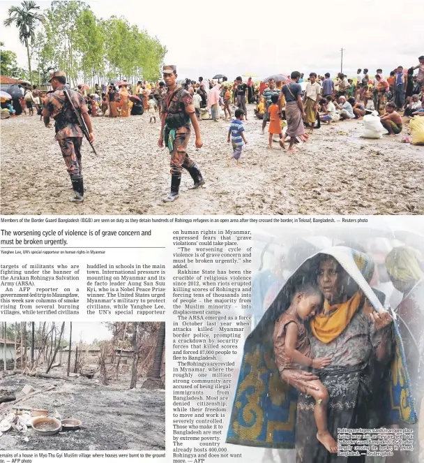  ??  ?? Members of the Border Guard Bangladesh (BGB) are seen on duty as they detain hundreds of Rohingya refugees in an open area after they crossed the border, in Teknaf, Bangladesh. Broken dishes can be seen in the burned out remains of a house in Myo Thu...