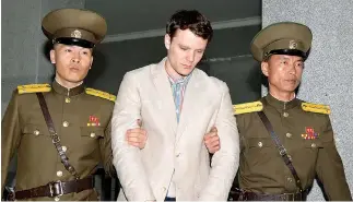  ??  ?? OTTO FREDERICK WARMBIER (C), a University of Virginia student who was detained in North Korea since early January, is taken to North Korea’s top court in Pyongyang, North Korea, in this photo released by Kyodo March 16, 2016.