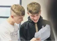  ??  ?? St Aidan’s Catholic Academy pupils check their results including, right, Rob Dunlop.