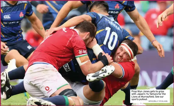  ?? INPHO/BILLY STICKLAND. ?? Prop Wyn Jones gets to grips with Japan’s Yu Tamura for the Lions at Murrayfiel­d. See our sports pullout.