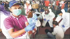  ??  ?? A JPVS staffer displays syringes of rabies vaccine during the exercise at Arang Road Basketball Court.