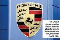  ??  ?? THE LOGO of German car maker Porsche is seen on a Porsche center in Niederwang­en near Bern, Switzerlan­d May 10, 2016.