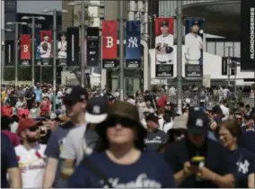  ?? TIM IRELAND - THE ASSOCIATED PRESS ?? FILE - In this June 29, 2019, file photo, fans arrive before a baseball game between the Boston Red Sox and the New York Yankees, in London. Major League Baseball is trying to muscle in on a crowded marketplac­e in Britain dominated by soccer but also filled with cricket, rugby _ and this month Wimbledon.