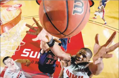  ?? Joshua Lindsey / Associated Press ?? Western Kentucky’s George Fant, right, fights for possession with Mississipp­i’s Sebastian Saiz during a 2013 game in Bowling Green, Ky. Fant spent most of his college days at Western Kentucky shooting basketball­s and grabbing rebounds as a physical power forward with big-time hoop dreams.