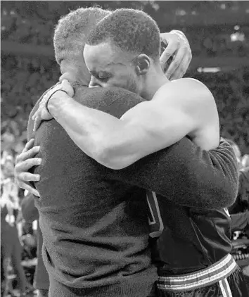  ?? MARY ALTAFFER/AP ?? Warriors guard Stephen Curry hugs his father Dell after scoring a three-pointer during the first half Tuesday at Madison Square Garden in New York. Curry hit his 2,974th career 3-pointer Tuesday night, breaking the record set by Ray Allen.