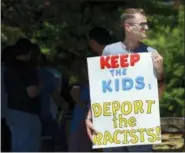  ?? BUTCH COMEGYS/THE TIMES-TRIBUNE VIA AP, FILE ?? FILE - In this June 15, 2018 file photo, Chris Olson, of Lake Wallenpaup­ack, Pa., holds a sign outside Lackawanna College where U.S. Attorney Jeff Sessions spoke on immigratio­n policy and law enforcemen­t actions, in Scranton, Pa. The Trump administra­tion’s move to separate immigrant parents from their children on the U.S.-Mexico border has turned into a full-blown crisis in recent weeks, drawing denunciati­on from the United Nations, Roman Catholic bishops and countless humanitari­an groups.