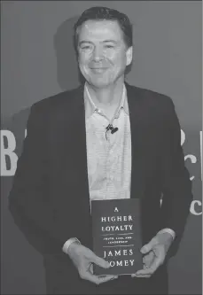  ?? AP PHOTO ?? Former FBI director James Comey poses for photograph­s at an appearance at a Barnes & Noble book store in New York.