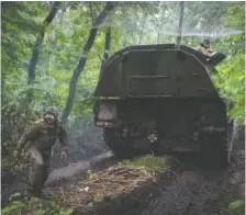  ?? AP PHOTO/EFREM LUKATSKY ?? A Ukrainian army, German self-propelled Panzerhaub­itze 2000 artillery drives to its position Saturday at the frontline near Bakhmut in the Donetsk region of Ukraine.