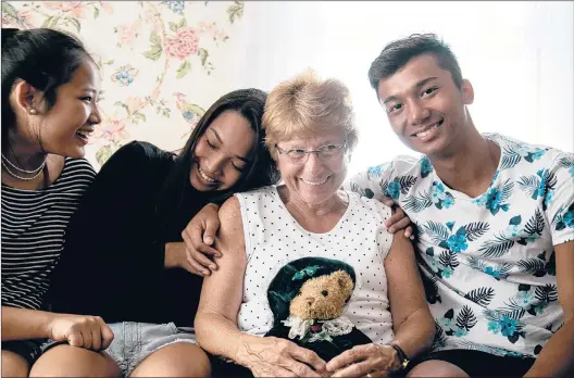  ?? SRIJITA CHATTOPADH­YAY | HARTFORD COURANT ?? BURMESE NATIVES Paw Say, 15, Nary Oo, 15 and Noble Oo, 18, embrace Mary Lou Connors, who helped them when they arrived in the U.S. about 10 years ago from a Thai refugee camp, where they were born. Connors, whom they call “Grandma,” and many others in the community welcomed the children, helping them adjust to American life.