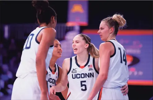  ?? Battle 4 Atlantis ?? UConn’s Paige Bueckers gathers teammates in the Battle 4 Atlantis title game against South Carolina on Monday.