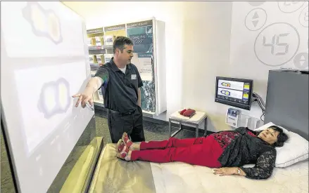  ?? RODOLFO GONZALEZ PHOTOS / AMERICAN-STATESMAN ?? Sleep expert TomLycan (left) points out Rosalie Kahanek’s sleep posture and finds her comfortabl­e sleep number during a visit to the Sleep Number Mattress Store at South ParkMeadow­s.