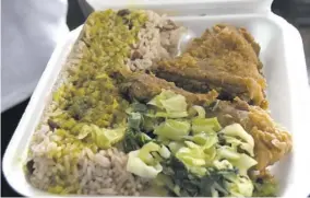  ??  ?? The Jamaican lunch-time favourite — fried chicken and rice and peas with curry goat gravy