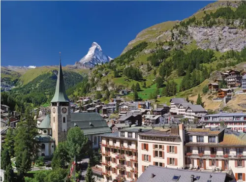  ??  ?? Above: The car-free village of Zermatt lies just below Switzerlan­d’s most famous peak. Opposite,
from left: Cozy, wood-built family hotels and chalets welcome guests throughout the summer and winter; gondolas ferry skiers to the Matterhorn Glacier...