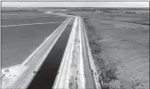  ?? Brian van der Brug
/ Los Angelestim­es /TNS ?? The Delta-mendota Canal (left) and a parallel canal under the Panoche Water District’s control (right) in June 2022 in Firebaugh, Fresno County.