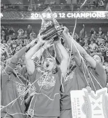  ??  ?? Iowa State players show off their hardware after defeating top-seeded Kansas 70-66 in the Big 12 championsh­ip game Saturday at Kansas City, Mo. It was the Cyclones’ second consecutiv­e conference tournament title.