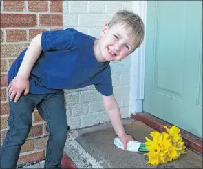  ?? Ref: 13-1521C ?? Four-year-old Henry Ellis delivers another bunch of daffodils