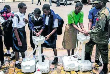  ?? (PHOTO: THE ECONOMIC TIMES) ?? Rwanda, Africa installed portable sinks and hand sanitizers in almost every public space and to avoid contaminat­ion, they have installed foot pedals to bring water to the taps instead of using hands.