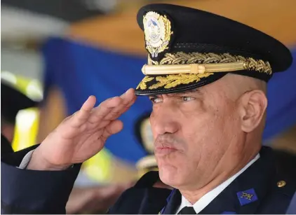  ??  ?? Honduras Police Chief Gen. Juan Carlos Bonilla Valladares, also known as the Tiger, or “El Tigre,” salutes during an event in Tegucigalp­a, Honduras, one year before he was fired on Dec. 19, 2013. According to a secret government security report,...