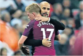  ??  ?? City harmony: Pep Guardiola hugs midfielder Kevin De Bruyne as he is taken off