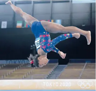  ?? NATACHA PISARENKO/AP ?? Simone Biles, of the United States, performs on the balance beam during women’s gymnastics qualifying Sunday in Tokyo.