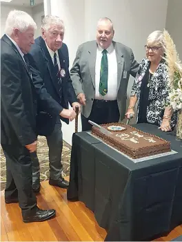  ?? ?? Graham Austin, Maurie Kilmartin, past district governor Terry Hayler and president Erika Wassenberg cut the 50th anniversar­y cake.