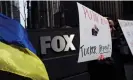  ?? Photograph: Shannon Stapleton/Reuters ?? People stand outside the News Corp and Fox News building in New York protesting against Tucker Carlson’s coverage of Russia’s invasion of Ukraine.