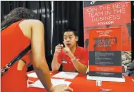  ??  ?? Jason Luong, employment recruiter for the Texas Station and Fiesta Rancho hotelcasin­os, talks to a job seeker Thursday during a fair hosted by the Las Vegas Review-journal.