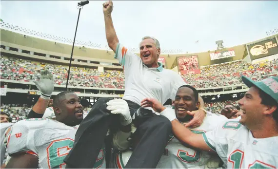  ?? GARY HERSHORN/REUTERS FILES ?? Dolphins players hoist coach Don Shula after beating the Eagles on Nov. 14, 1993. It was Shula’s 325th career win, making him the NFL’S all-time leader.