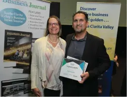  ?? Dan Watson/For The Signal ?? Scott Capistrano of Status Not Quo poses for a photo with SCVEDC President and CEO Holly Schroeder after accepting the CEO of the Year award on Thursday night at the Santa Clarita Valley Business Journal’s Technology Awards at CalArts.