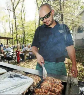  ?? THE NEWS-HERALD FILE ?? Jay Raddell of Cleveland’s Raddell’s Sausage Shop works the grill at the 2015 Slovenian Sausage Festival at SNJP Farm in Kirtland.