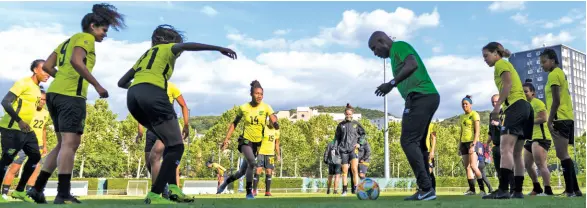  ?? FILE ?? Lorne Donaldson (centre, right) the assistant coach at the FIFA Women’s World Cup in 2019, joins Reggae Girlz in training drills at a session at Stade Eugene Thenard in Grenoble, France on Sunday, June 16, 2019 ahead of the Group C match against Australia.