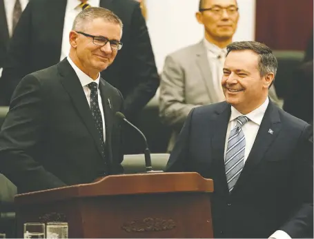  ?? LARRY WONG ?? Finance Minister Travis Toews, left, and Premier Jason Kenney are all smiles after Toews delivered his provincial budget speech at the Alberta Legislatur­e on Thursday.