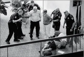  ?? ASSOCIATED PRESS ?? CAPITOL HILL POLICE OFFICERS ARREST A GROUP PROTESTING the Republican healthcare bill outside the offices of Sen. Dean Heller, R-Nev., on Capitol Hill in Washington on Monday.