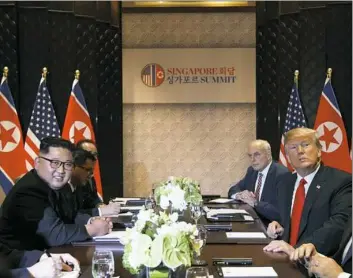  ??  ?? Mr. Trump meets with the North Korean leader, left, Tuesday on Sentosa Island in Singapore.