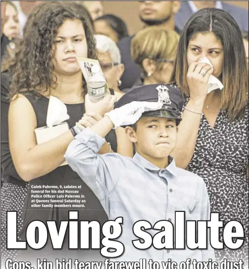  ??  ?? Caleb Palermo, 9, salutes at funeral for his dad Nassau Police Officer Luis Palermo Jr. at Queens funeral Saturday as other family members mourn.