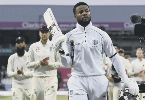  ??  ?? 0 Twin centurion Shai Hope walks off in triumph after scoring the winning runs for West Indies against England at Headingley.