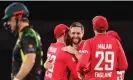  ?? Photograph: David Gray/AFP/Getty Images ?? Chris Woakes celebrates with teammates after dismissing Mitchell Marsh (left).