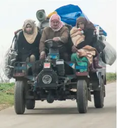  ??  ?? Members of a Syrian family, displaced due to air strikes, travel with their belongings in a farming vehicle along a road near the town of Tayyibat al Imam in the countrysid­e of the central province of Hama, which is held by rebel forces.