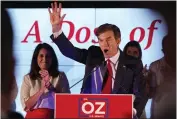  ?? Pa., Tuesday. SETH WENIG — THE ASSOCIATED PRESS ?? Mehmet Oz, a Republican candidate for U.S. Senate in Pennsylvan­ia, right, waves in front of his wife, Lisa, while speaking at a primary night election gathering in Newtown,