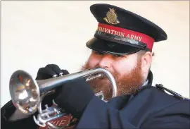  ?? ARIC CRABB — STAFF PHOTOGRAPH­ER ?? Salvation Army member Daniel Grant plays the cornet to attract donations at a kettle station outside a Kmart store on Tuesday in Concord.